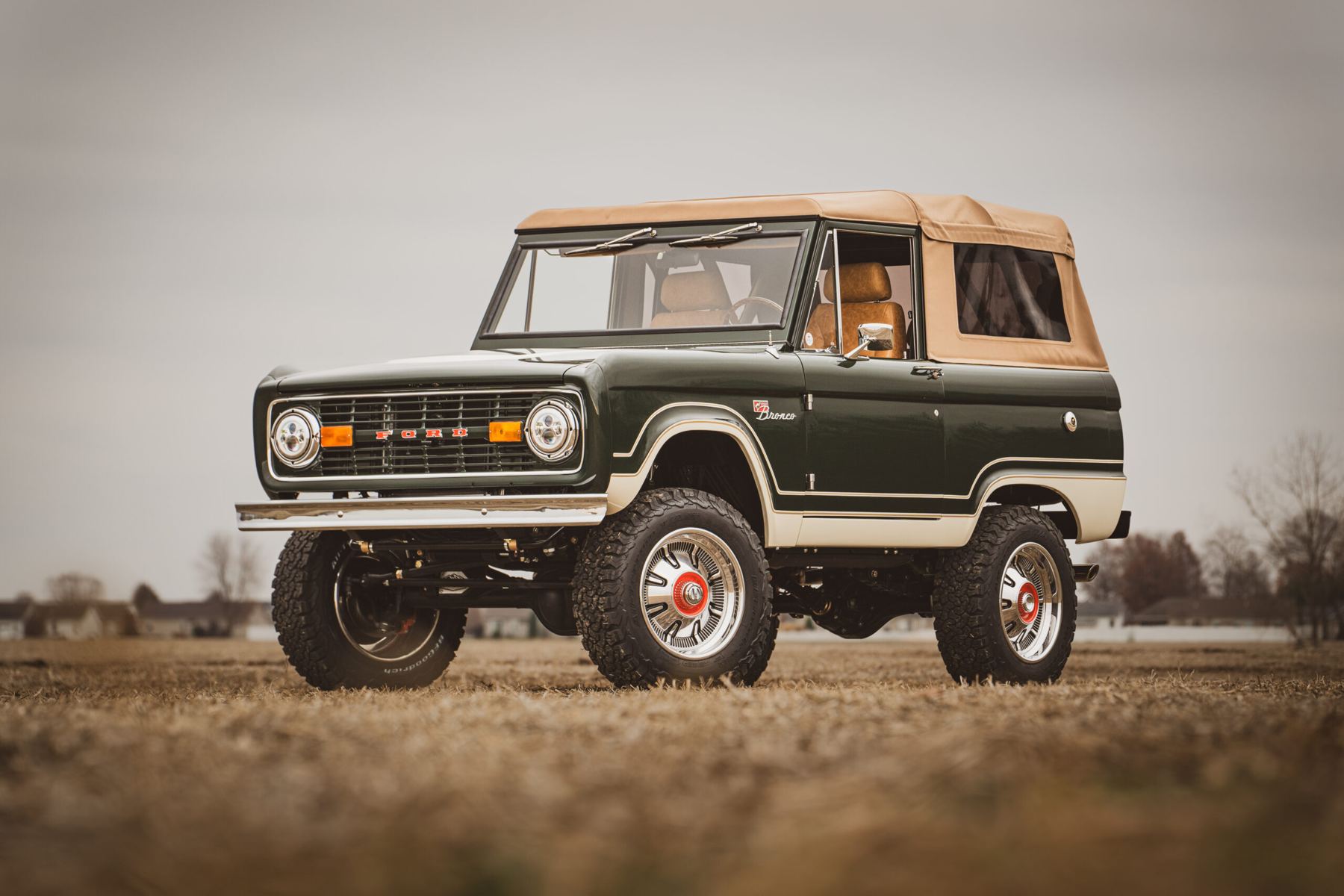 Vintage green convertible 4x4 parked in a field