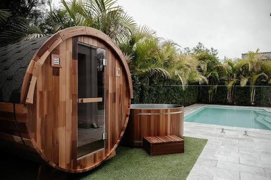 Backyard pool with a cedar barrel sauna and hot tub